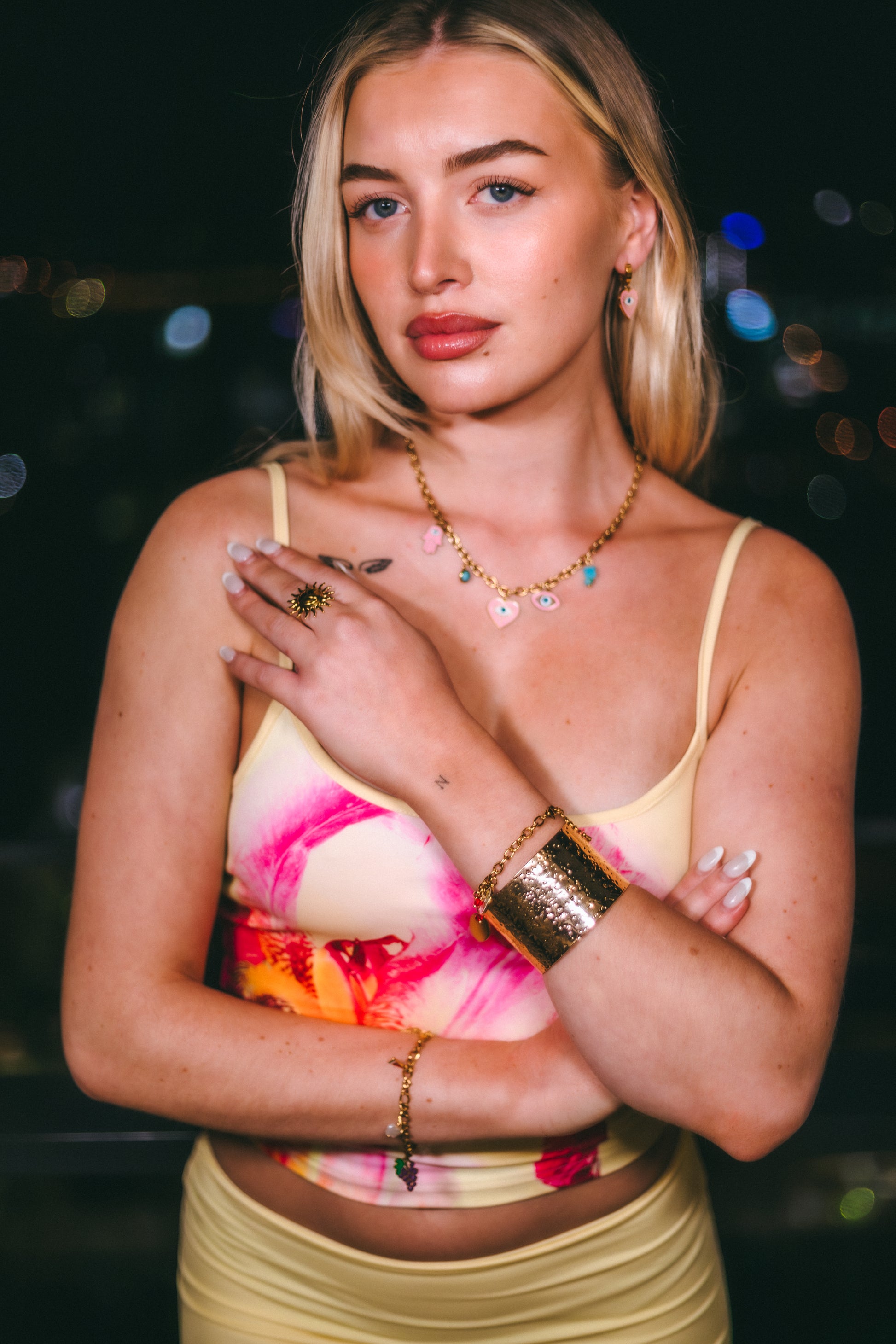 Woman wearing a colorful top with a blurred bokeh background