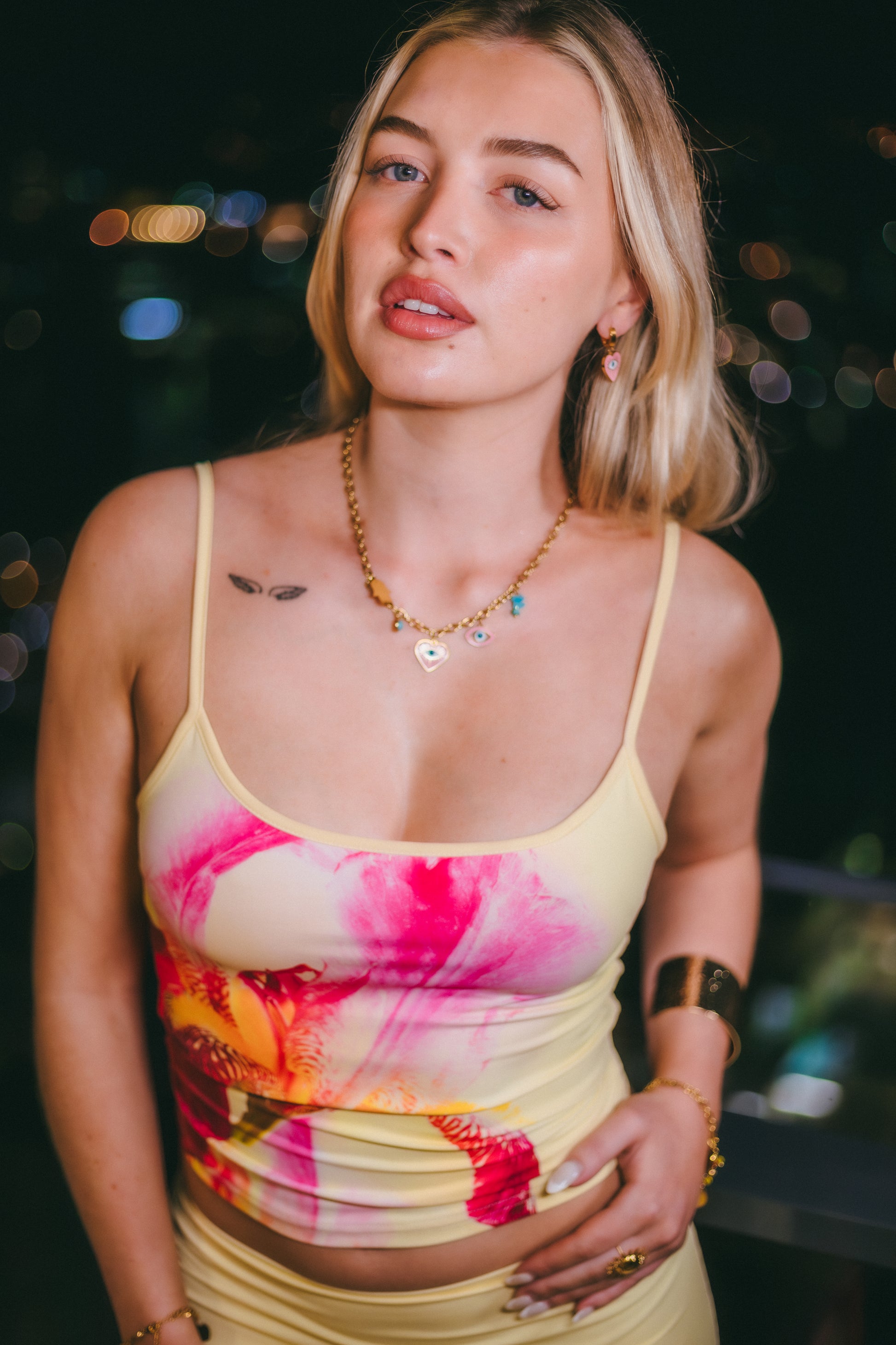 Woman wearing a colorful tank top with a blurred background