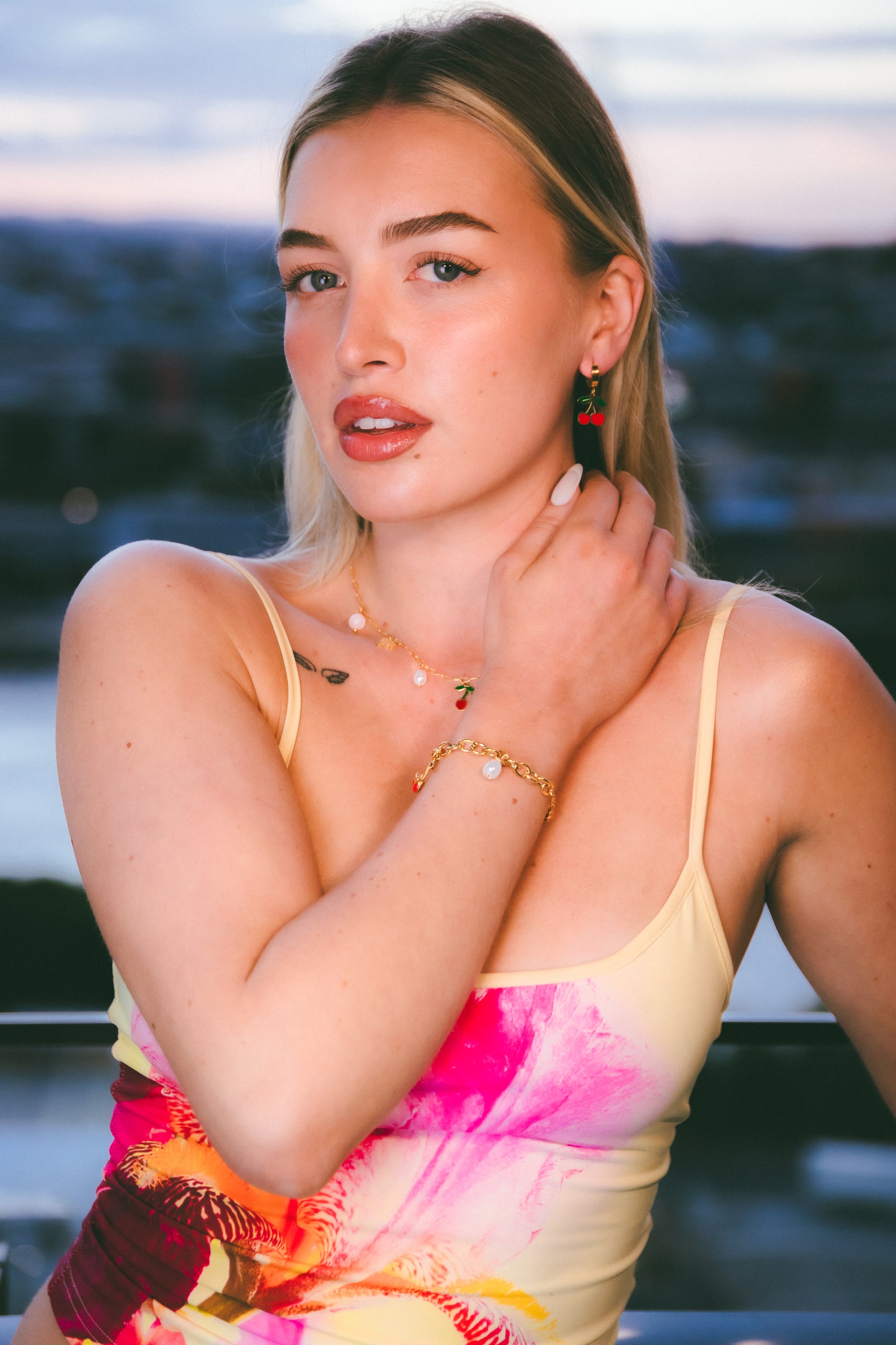 Woman wearing a colorful dress with a blurred outdoor background